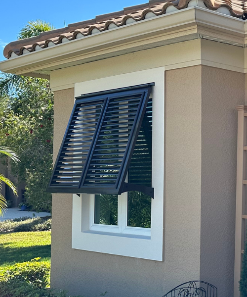 Face mounted Bahama Shutter installed on white trim. 