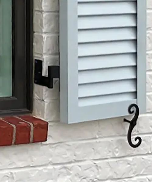 Face mounted Bahama Shutter installed on white trim. 